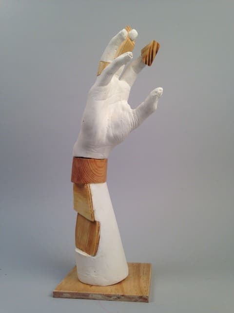 Hand sculpture with wooden accents, modern art piece from Albuquerque Academy.