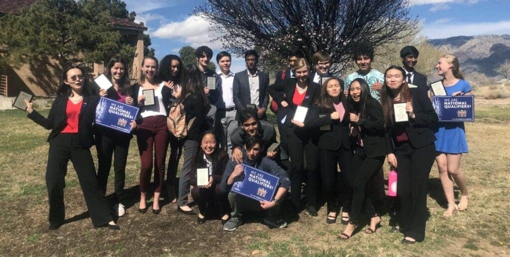 Highly performing Albuquerque Academy students celebrating academic achievement outdoors.