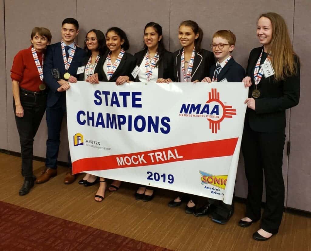 Albuquerque Academy students celebrating state championship at mock trial event.