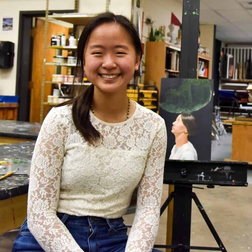 Creative student at Albuquerque Academy art studio, painting and learning.