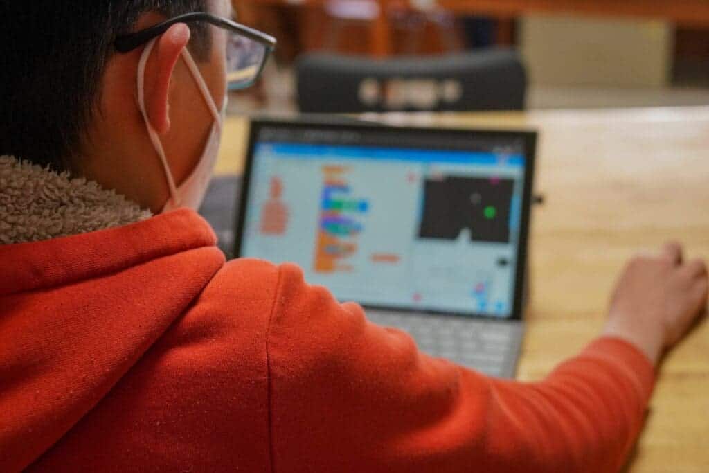 Student working on educational computer programming project at Albuquerque Academy campus.