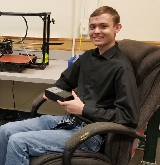 Innovative student working on 3D printer at Albuquerque Academy computer lab.