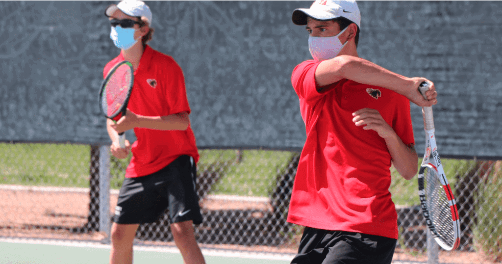 Tennis players practicing on outdoor court at Albuquerque Academy.