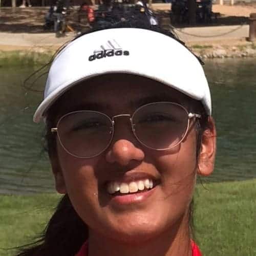 Modern student smiling outdoors at Albuquerque Academy golf course.