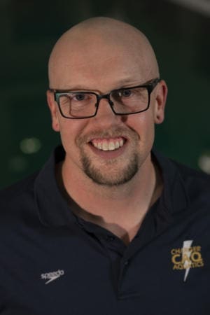 Albuquerque Academy faculty with friendly smile in school environment.