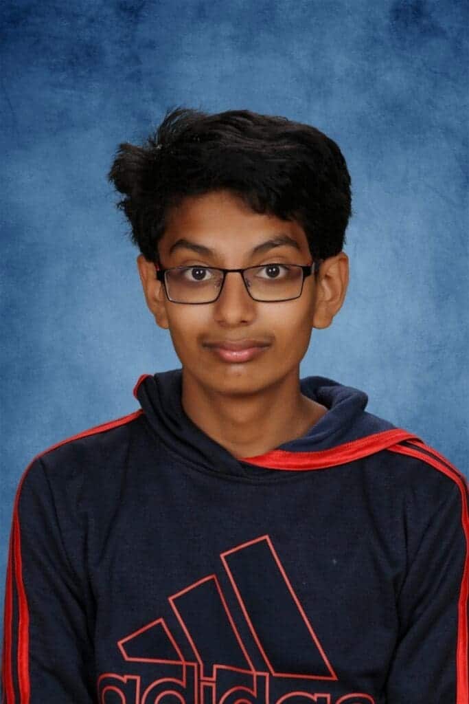 Dedicated Albuquerque Academy student in school hoodie and glasses.