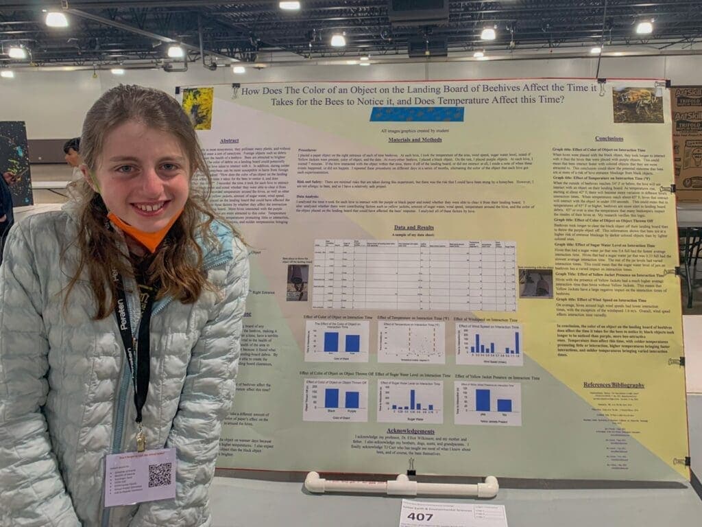 Bright young student presenting science project at Albuquerque Academy science fair event.