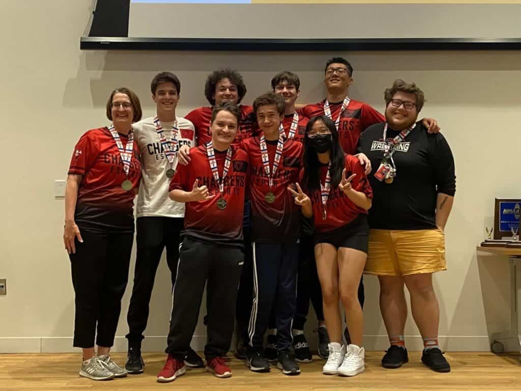 Champions sports team celebrating with medals at Albuquerque Academy event.