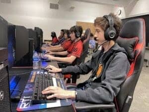 Young students engaging in computer gaming or coding class at Albuquerque Academy technology lab.