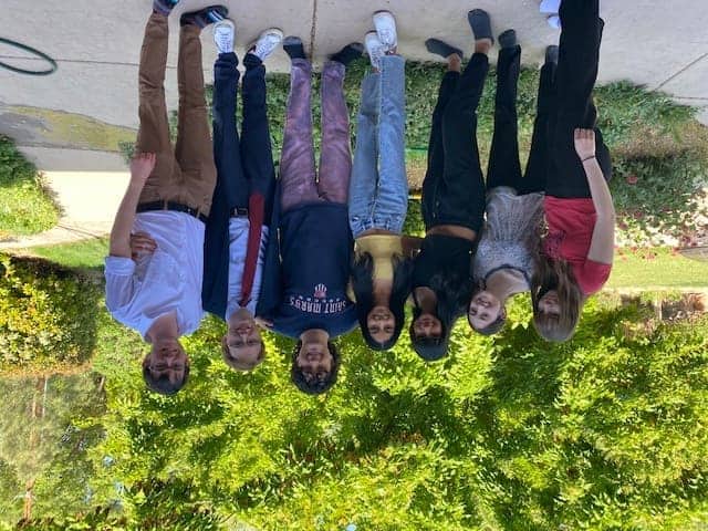 Students standing outdoors at Albuquerque Academy campus for educational activities.
