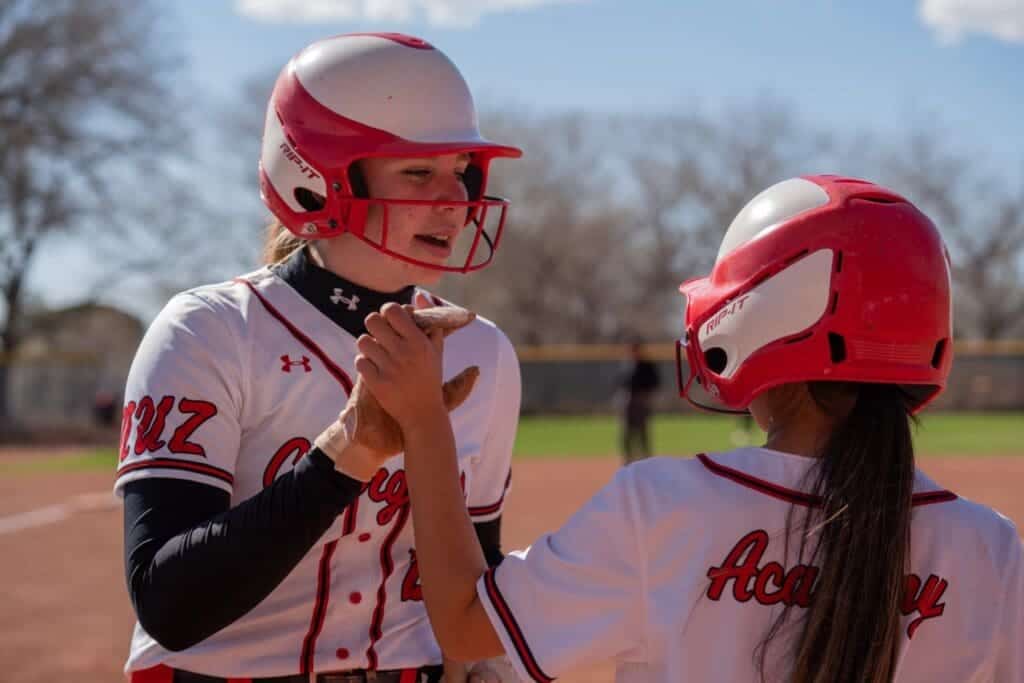 Girls softball players celebrating after a game at Albuquerque Academy.