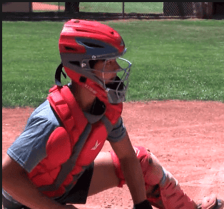 Young baseball catcher in protective gear on field at Albuquerque Academy.