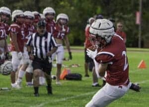 Football player catching ball during game.