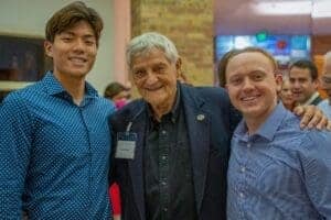 Diverse students and an older man smiling at Albuquerque Academy event in New Mexico.
