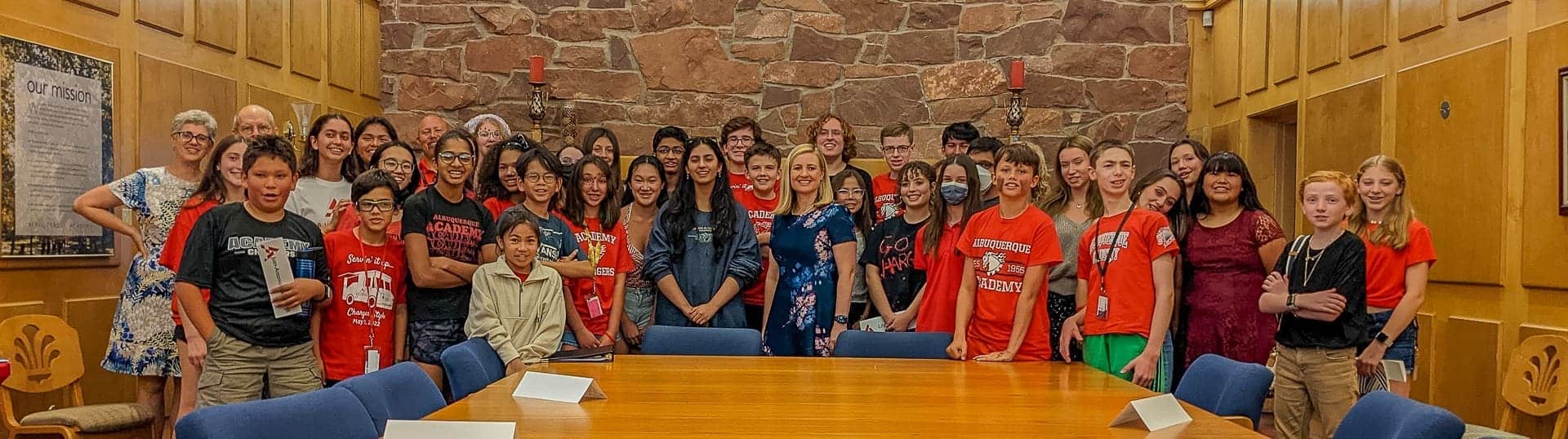 Diverse students at Albuquerque Academy gathering in a classroom setting.