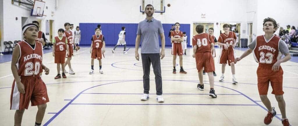 Indoor basketball game at Albuquerque Academy sports facility.