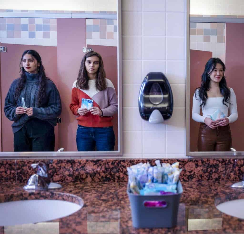 Students waiting in school bathroom line, Albuquerque Academy campus, student activities, diverse teens, high school education, campus life.