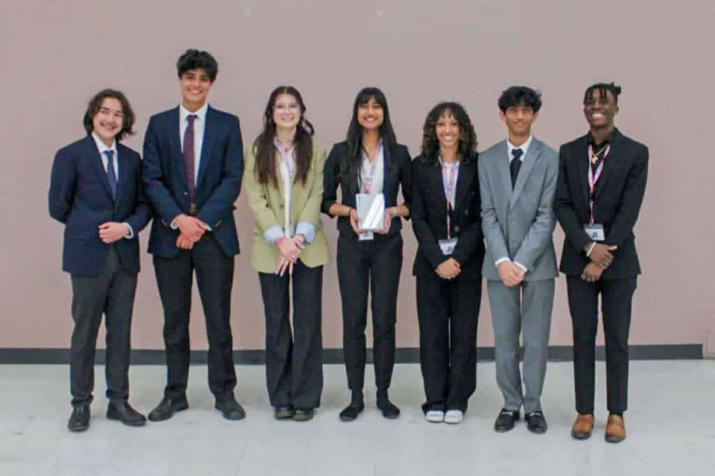 Diverse students at Albuquerque Academy in formal attire posing for a photo.