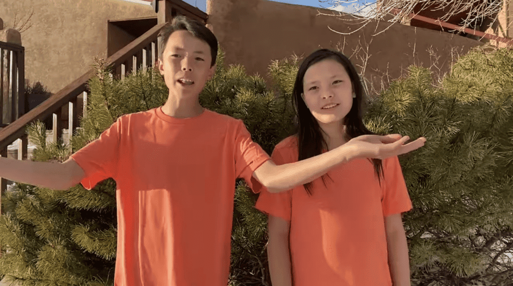 Young students outdoors at Albuquerque Academy campus, emphasizing education and community.