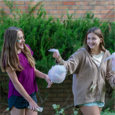 Children enjoying outdoor activities at Albuquerque Academy campus during fall.