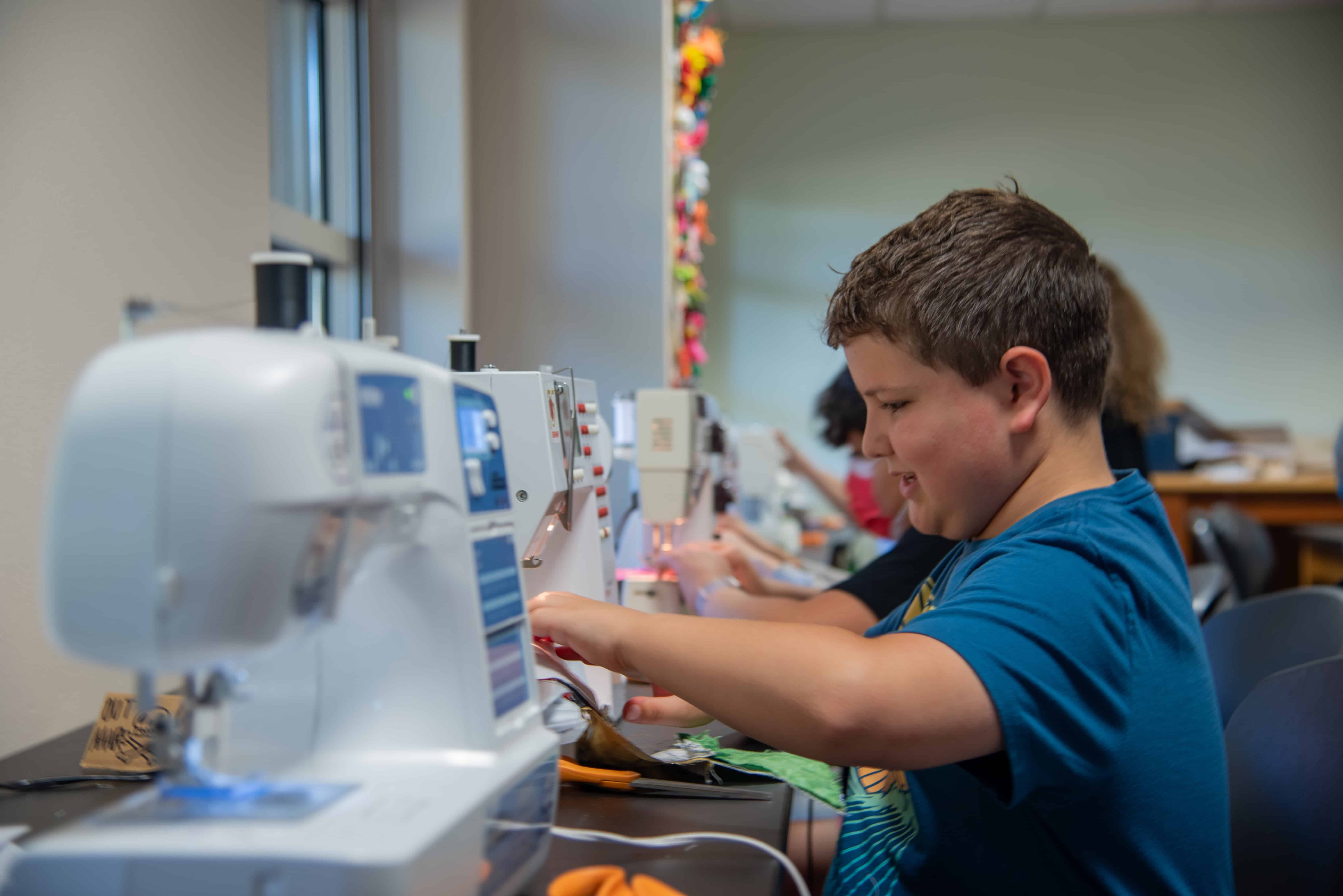 Students working on sewing machines at Albuquerque Academy, STEM education and technology focus.