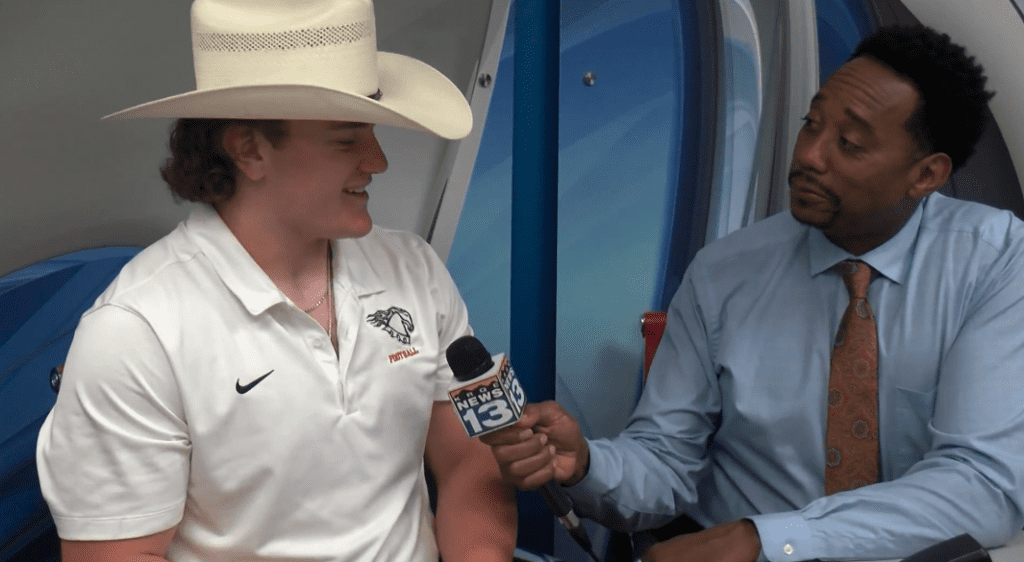 Young woman in cowboy hat being interviewed, Albuquerque Academy student, school news.