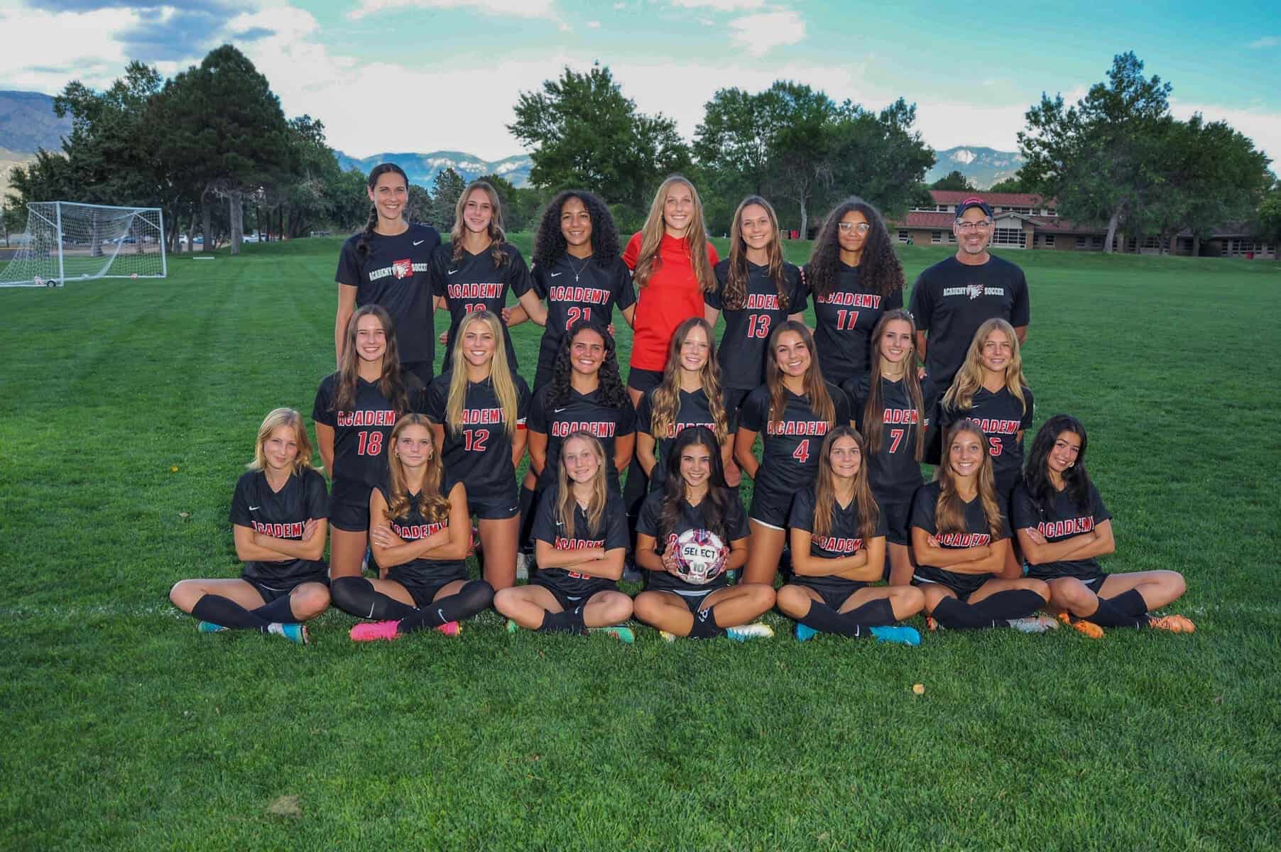 Girls soccer team at Albuquerque Academy on a lush green athletic field in New Mexico, showcasing school sports excellence.