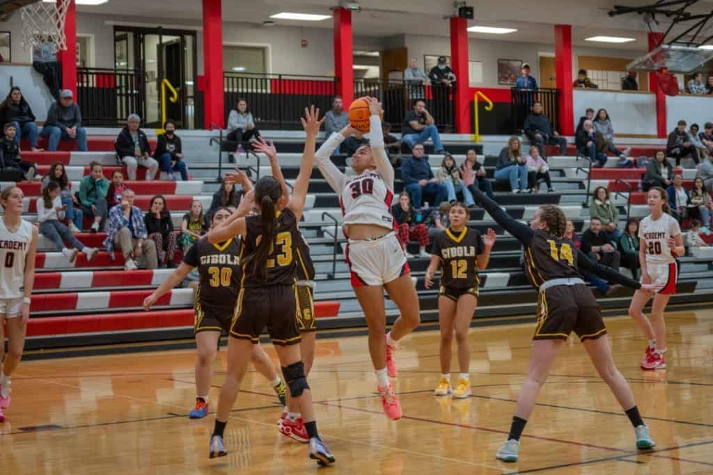 Albuquerque Academy basketball game featuring students in action amidst engaged spectators.