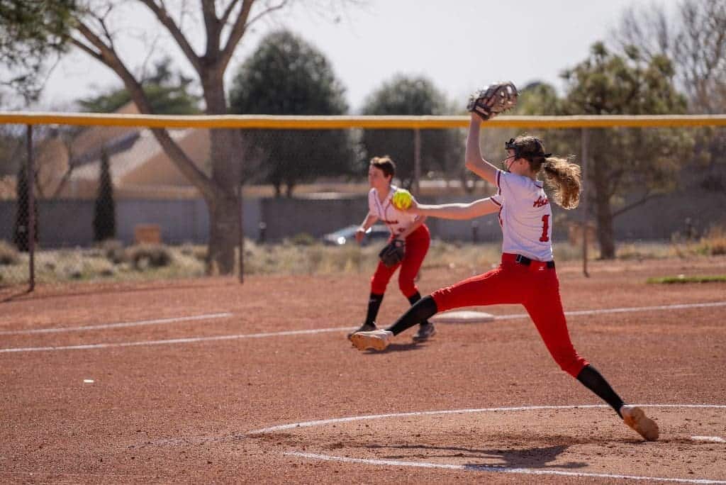 Young female softball player making a play on the field.