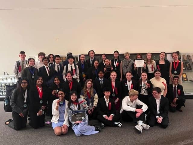 Innovative Albuquerque Academy students participate in academic competition with medals and awards.