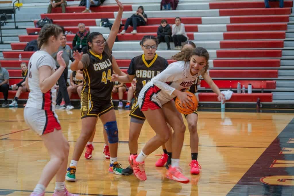 Young female athletes competing in basketball at Albuquerque Academy, highlighting school sports programs.