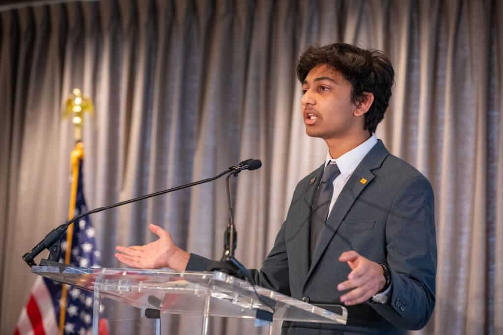 Young student giving a speech at Albuquerque Academy event, demonstrating leadership and academic excellence.