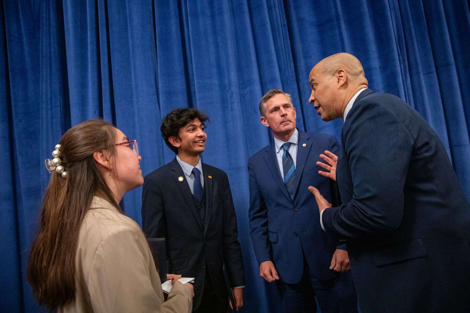 Group discussion with man gesturing earnestly.