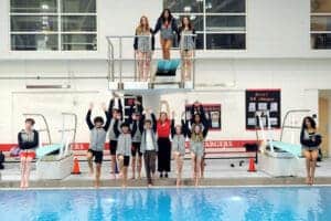 Swim team group photo by poolside.