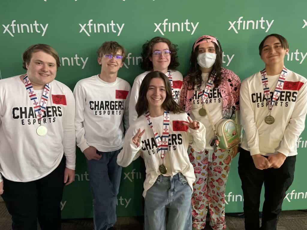 Esports team with medals at event.