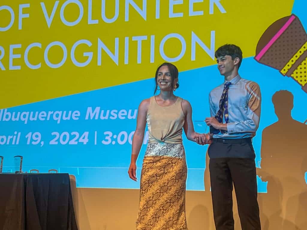 Diverse students recognized at Albuquerque Academy volunteering event, celebrating achievement and community engagement.