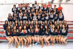 Group of students in matching team jackets.