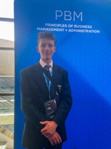High school student at Albuquerque Academy attending business management event, showcasing academic excellence and leadership.