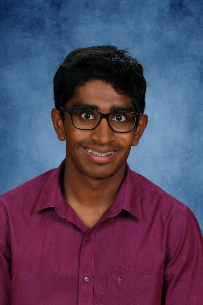 Bright student with glasses smiling, Albuquerque Academy private school in New Mexico.