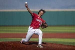 Albuquerque Academy baseball pitcher pitching on the field during game.