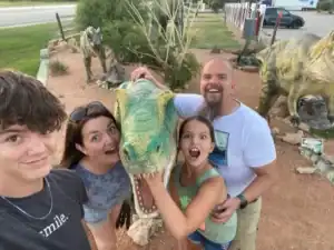 Dinosaurs and children at Albuquerque Academy dinosaur exhibit outdoor class.