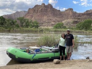 Rafting on the Colorado River near a desert canyon with family and scenic landscape.