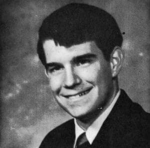Young man in formal attire, vintage portrait, black and white photo.
