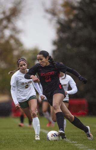 Athletic female soccer players competing outdoors at Albuquerque Academy campus.