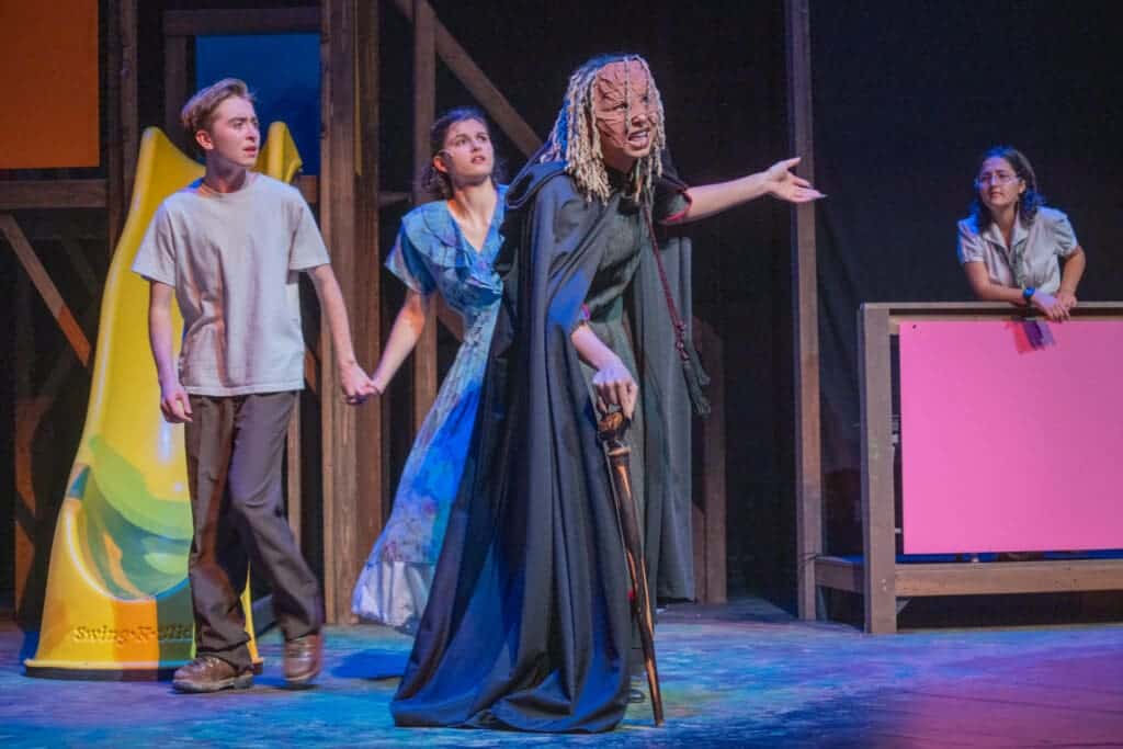 Exciting theater performance at Albuquerque Academy showcasing students in a school play or musical on stage with actors in costume and vibrant scenery.