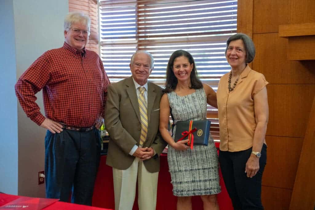 Smiling group of adults at Albuquerque Academy event, celebrating achievement and community.