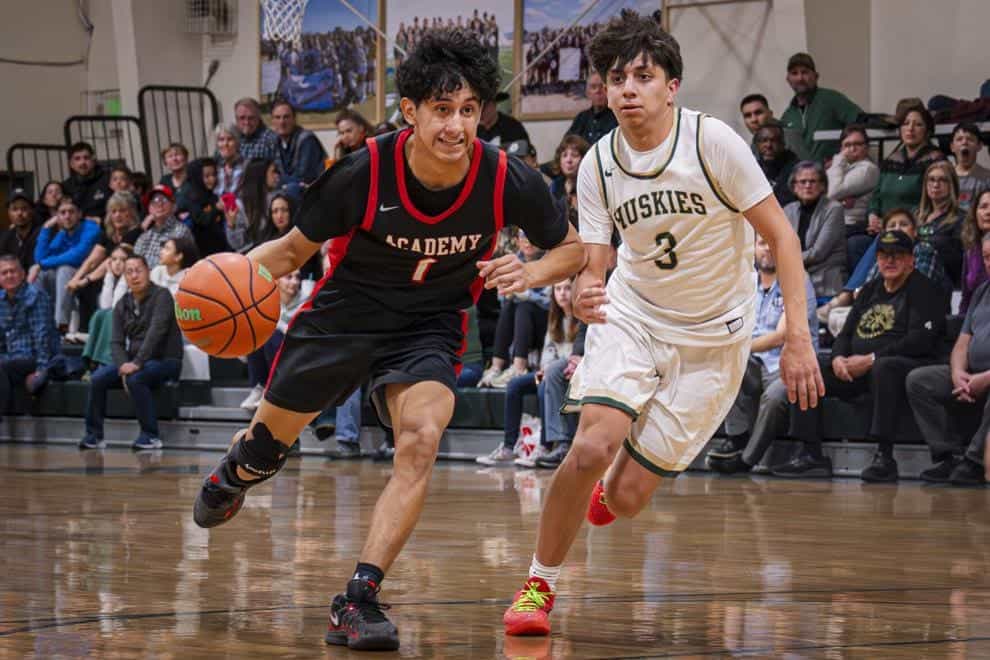 Albuquerque Academy basketball game with students and spectators in gymnasium, showcasing school sports.