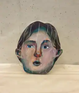 Facial art sculpture representing creativity at Albuquerque Academy campus.