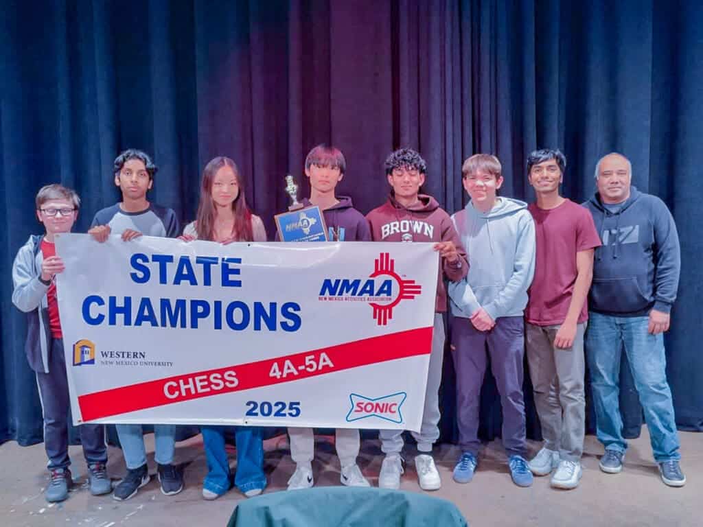 State chess team celebrating New Mexico state championship victory at Albuquerque Academy.