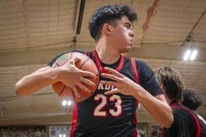 Albuquerque Academy student playing basketball in gymnasium, showcasing athletic programs.